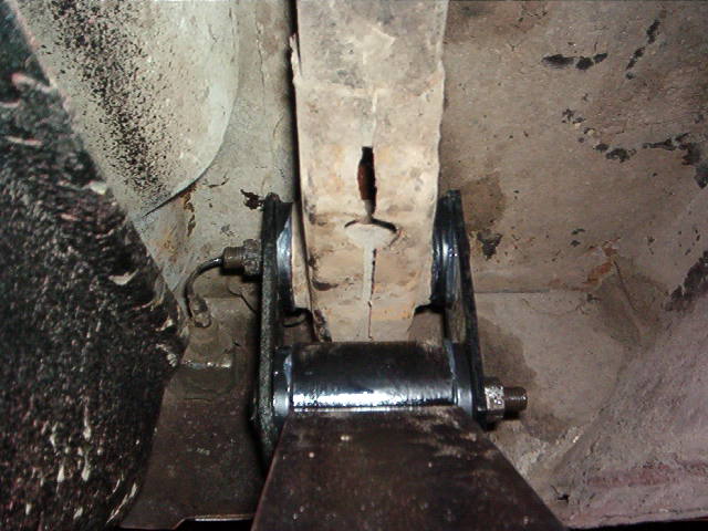 Here you have the correct orientation of the rear leaf spring hangers and thru bolts.  The nuts torque down onto the plates solid.  The threads only go so far.  Once the nut has bottomed out there is not one more thousandth of squish left.