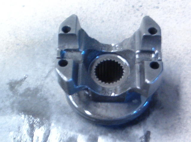 Here is the Pinion Flange properly painted and drying.  I blast them and then make sure that every little problem is dealt with.  Chase the threads, repair the seal groove, check the flange to pinion spline lash and check for cracks.