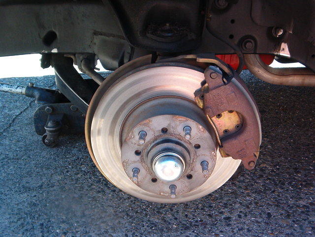 Just look at those incorrect aftermarket brake backing plates.  I am just pissed off to no extent about these little items.  I ordered a set and found out they are junk.  Just look at the wear line on his caliper.  Worn almost to the pins.