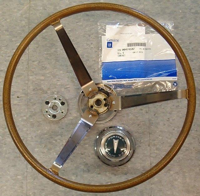 You can see the GM Contact Package.  I left them in the package for you to fondle.  I do not like loosing small parts.  You will just have to pop out the center emblem and screw in the adapter to the collar.  Then use your old steering wheel nut.