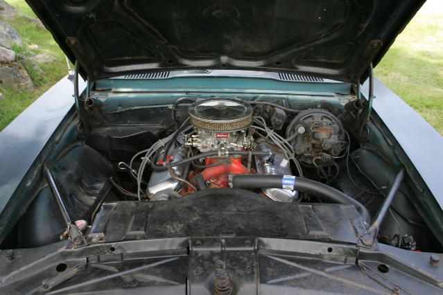 Look what is under the hood.  This Camaro guy must of been a real smart feller.  He pulled the Ram Air Motor, Transmission, Interior, Differential, Steering Wheel, and who knows what else out of the Firebird.