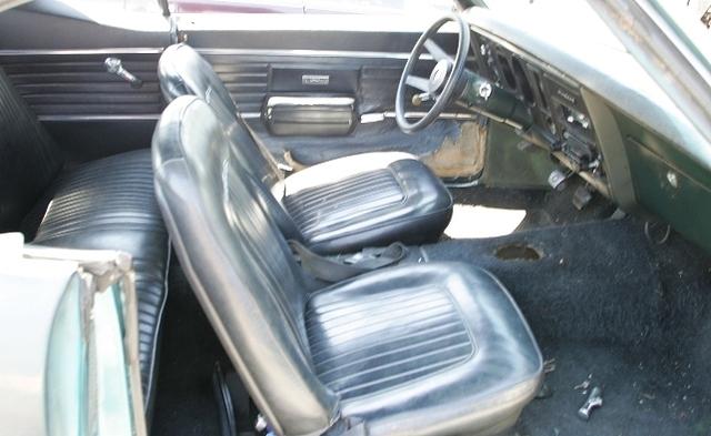 Oh and how about the Steering Wheel also.  Nice deal.  Tell you what, how about I trade you these fine parts for the Fold down rear seat, wood wheel, deluxe door panels and Ram Air engine that was here first.