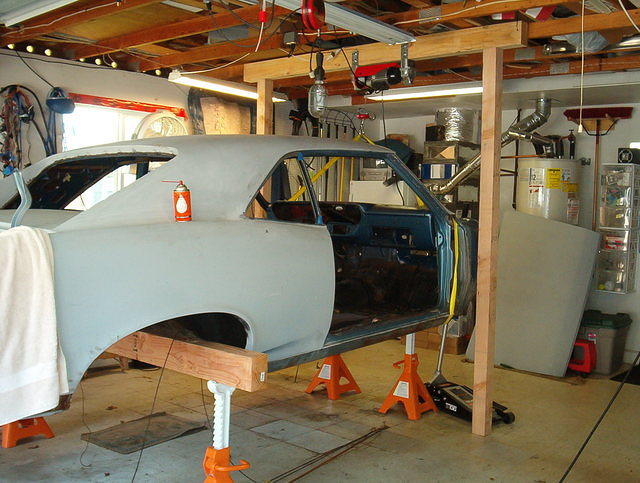 Here is the body.  Now Jim likes to get his hands dirty.  I told him to just put it on Jack Stands.  He was so proud of the body that he hung it from the roof like a poached moose.