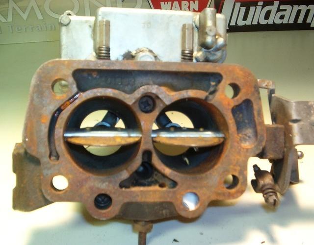 Then there are other cases when the whole carburetor has a plethoria of garbage on it.  Not even the bottom baseplate on this carburetor is serviceable.  It is for a Chevrolet.