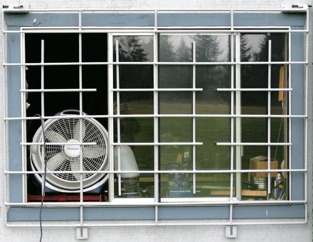 Here are our pretty coated window grates.  We have taken the tme to make sure that these are quite impenetrable.  Yes, that and Mr. Smith and Wesson ought to help out.