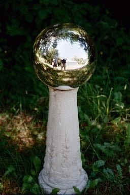 This is the Real Deal.  The Pedestal is blesssed and as such has captured this globe.  You have to watch these things, once loose they fly around.  Just see the Movie "Phantasim" if you got questions.