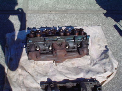 Here is the shot of the complete Cylinder Head and Exhaust Manifold removed as an assembly.  It is far easier to remove stubbon Exhaust Manifold bolts in this manner.  Most non experienced Machine Shops will break the studs and then charge the customer...