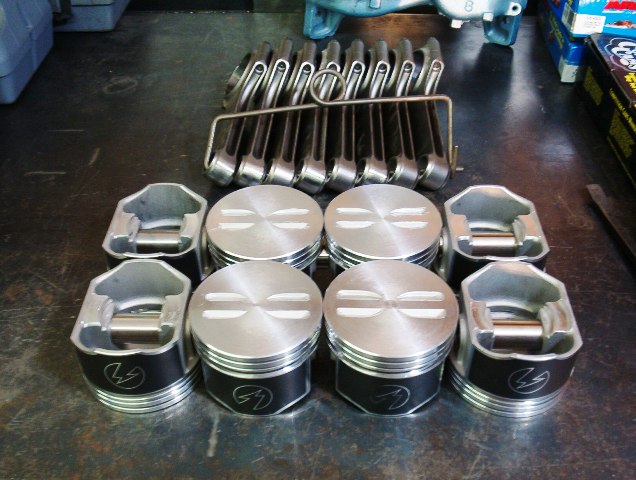 Here is a better shot of the tops of the pistons.  You will notice that the metal where I removed some metal is nice and shiny.  Just a little shave here or there to lower compression.