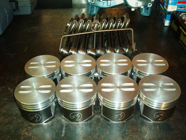 I will have to remember to take a picture of the pistons before we turn them.  They need to be a bit lower in the bore to lower the compression.  I have been doing this for years and Wedge Heads have to have it done this way.