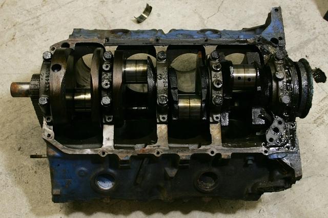 You can see that the lower end of this motor has not been screwed up.  The caps are all correct.  The Main Cap Bolts are all OEM original.  Even the Timing Cover Studs.