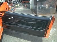 Passenger side deluxe door panel and lower plastic armrest.