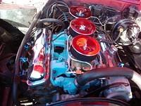 Here is the same car with the TRIP installed.  You will notice that the upper alternator bracket attaches to the water pump.  I have seen many this way and I believe that they all attach this way.  The boss that is cast into the intake manifold is indi...