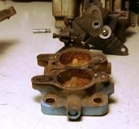 You will also notice that the Throttle Shaft is not cut off like was done to the 60's era center carb on his intake setup.  This one is recessed.  That was for a reason.  You see there was a small cup plug that is driven in to prevent fuel from leaking...