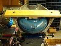 You will notice that I have taken the added effort to fabricate a piece of wood to span the front of the bellhousing.  It bolts into the bellhousing lower bolt holes.  I have also included a spacer block glued to the wood to keep the torque converter s...