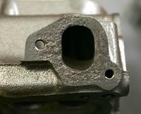 You put a piece of Wax paper against the JB Weld and the Manifold Flange.  If you are lucky the wax paper will not rip and the manifold will come off the next day.  The rusted areas will be filled.